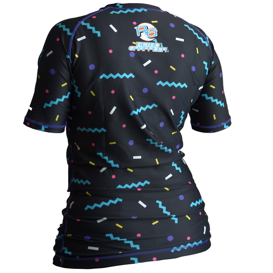 A person seen from behind wears the Leglockers Barbie Parody Rash Guard by Retro Grappler, featuring a fitted black short-sleeve design, colorful retro patterns, and PG Retro Grappler text on the back, with four-way stretch fabric for comfort and flexibility.