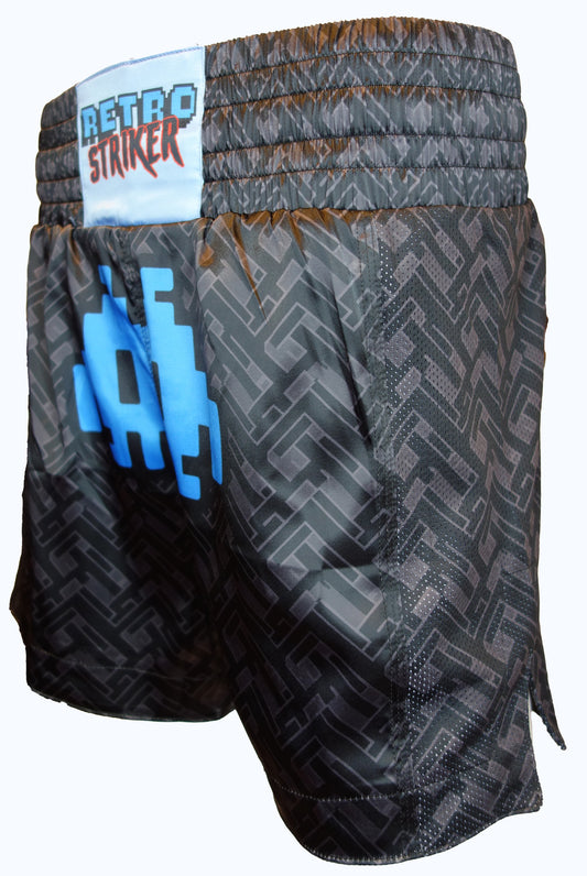 Dark Labyrinth Muay Thai Shorts by Retro Grappler feature a pixelated blue geometric design, elastic waistband, 5 inseam, and bold blue and red Retro Grappler branding on the waist.