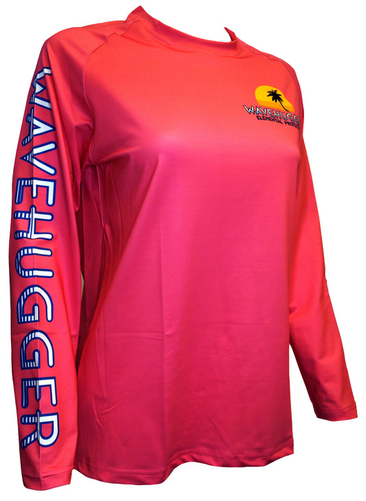 The Turtles and Surf Performance Shirt by Wave Hugger is a bright pink, long-sleeve rash guard with moisture-wicking fabric and features a sun, palm trees, and the Wave Hugger Ocean Educators logo on the chest.