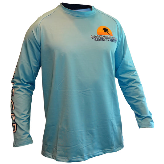The Tattle Tails Performance Shirt by Wave Hugger is a light blue long-sleeve fishing shirt with UPF 50+ protection, WAVEHUGGER ELEMENTAL PROTECTION, a palm tree chest graphic, and white Wave Hugger text on the left sleeve.