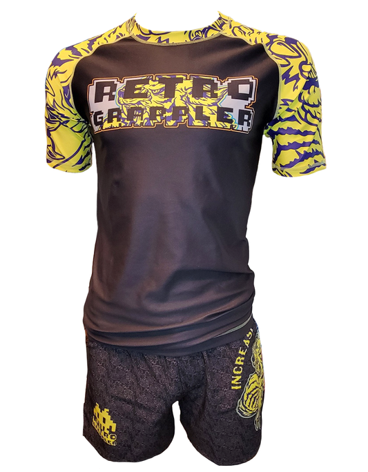The Tiger Pressure BJJ Rash Guard by Retro Grappler is a black and yellow athletic set with short sleeves and shorts, featuring bold grappling-inspired graphics, Retro Grappler text on the top, and Increase on the shorts.