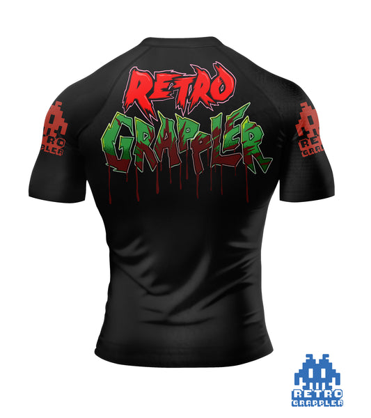The Retro Grappler Jason V Horror Jiu Jitsu Rash Guard is black with pixelated red sleeve designs, graffiti-style Retro Grappler text on the back, and a blue pixelated Retro Grappler logo at the bottom right.