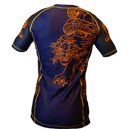 The Retro Grappler Panther Old School Tattoo Style Rash Guard is a navy blue athletic rashie with yellow stitching, featuring a bold orange snake coiled around a roaring tiger on the back in classic Sailor Jerry tattoo art style.