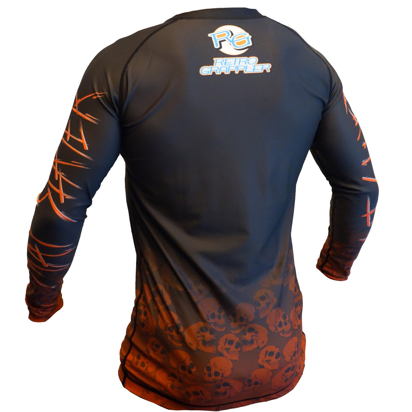 The Youth - Mat Slayer by Retro Grappler is a black and orange long-sleeve shirt inspired by metal album covers, featuring bold skulls, stylized orange scratch marks on the sleeves, and a logo on the upper back.