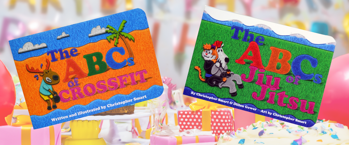The Retro Grappler ABCs Of Childrens Book Bundle is displayed upright among birthday decorations, gifts, and balloons, featuring playful felt-style cover art.