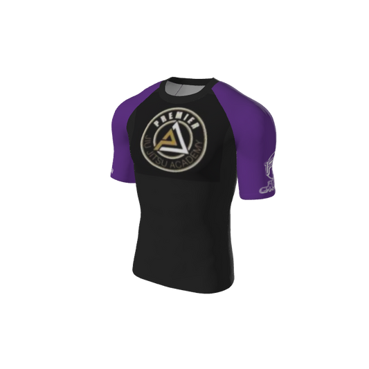 The Custom Retro Grappler Custom Single Color Short Sleeve Rash Guard (black and purple) features the “Premier Jiu Jitsu Academy” chest logo and a small white sleeve logo—ideal for grapplers seeking style and performance.