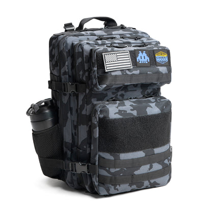 Camouflage backpack with American flag patch and visible branding on a white background
