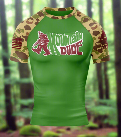 Green t-shirt with camouflage sleeves and 'Mountain Dude' logo on a white background